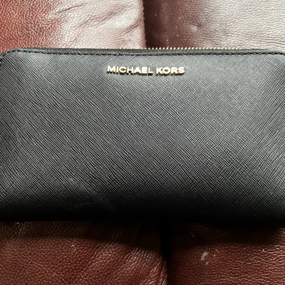 Black Michael Kors Wallet.  It is missing the wrist strap